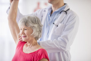 Senior resident and therapist in physical therapy session